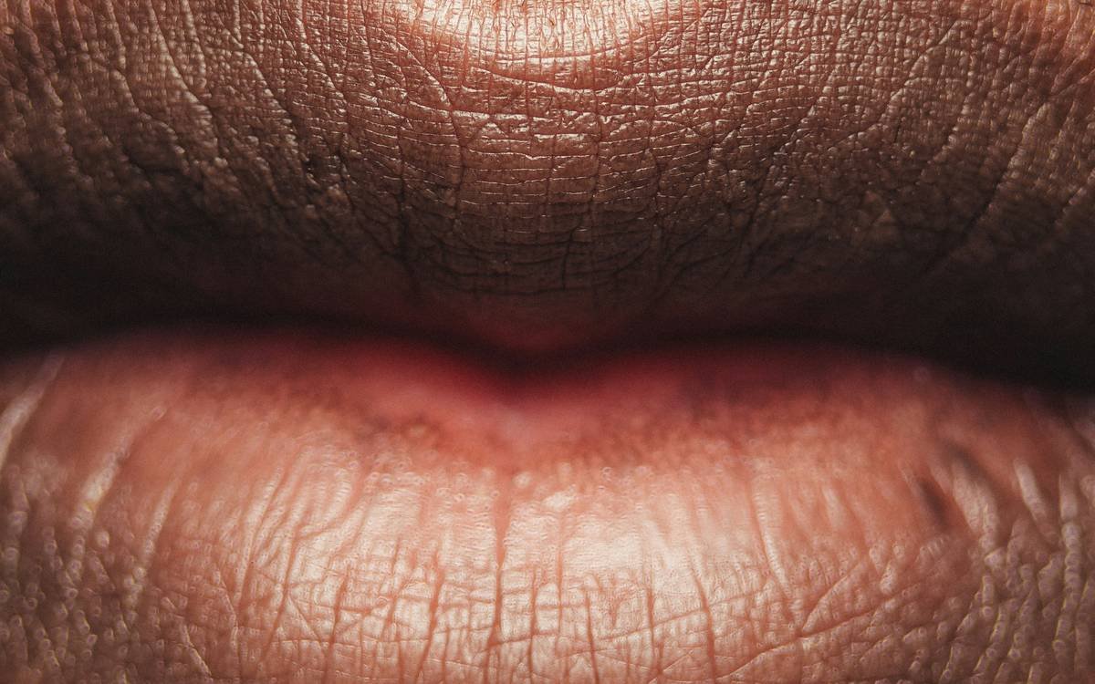 Close-up of model wearing bold high-fashion lip looks with sharp contouring and vivid pigment